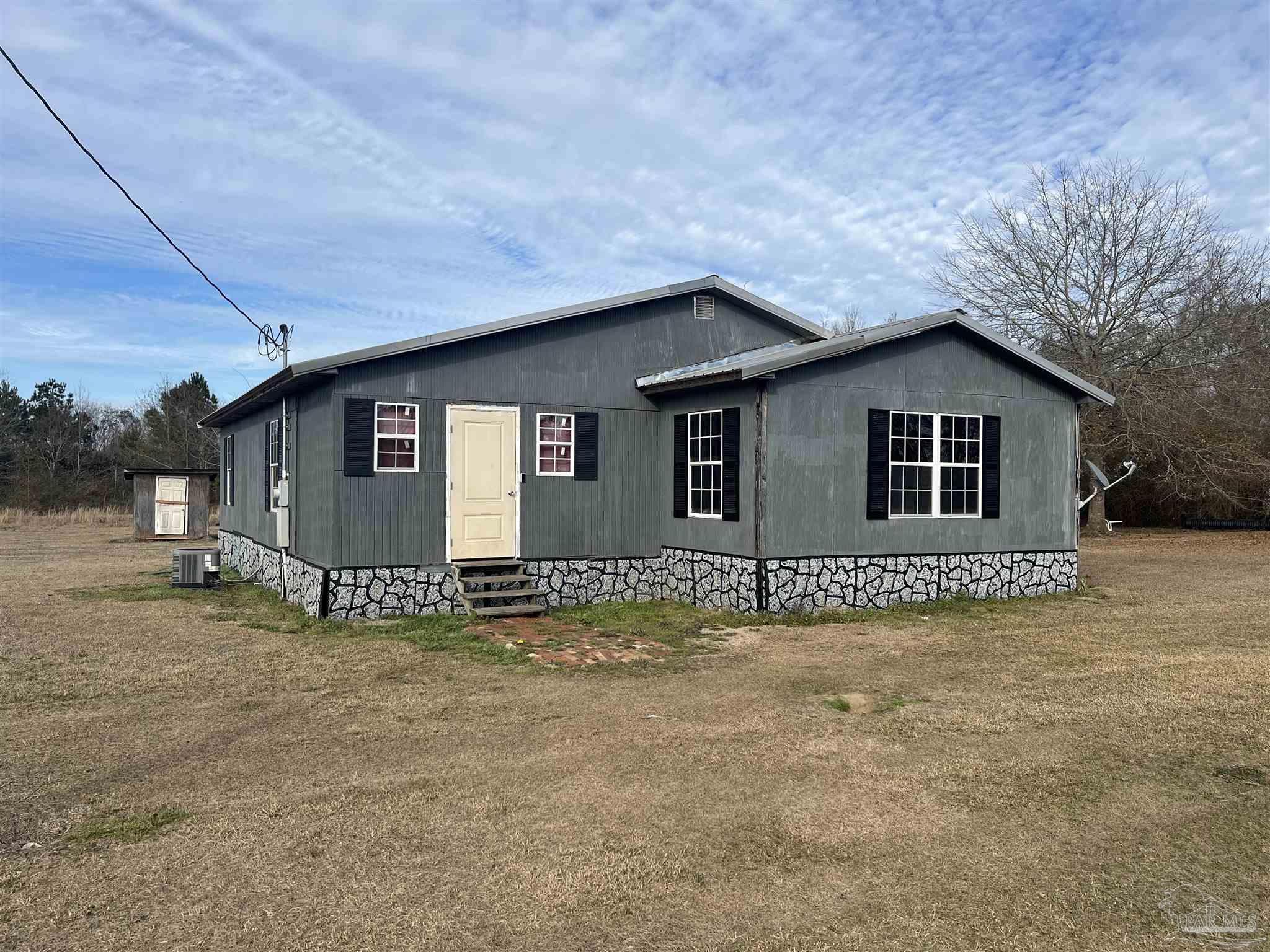 1482 Smith Dairy Road Atmore, AL 36502 - Photo 1 of 34 a view of a house with a yard and large tree