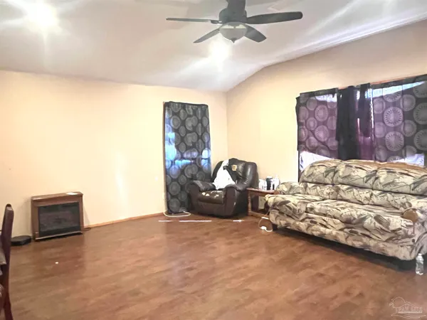 a bedroom with furniture and a flat screen tv
