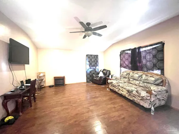 a living room with furniture and a flat screen tv