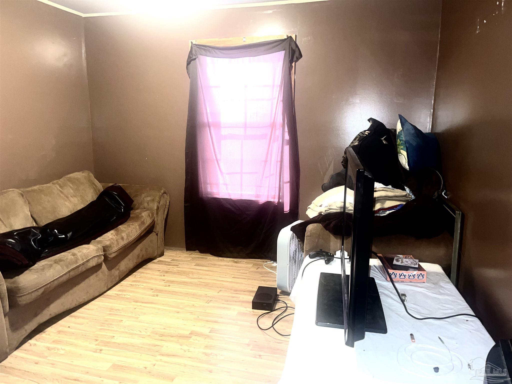 1482 Smith Dairy Road Atmore, AL 36502 - Photo 9 of 34 a bed room with a bed and a couch