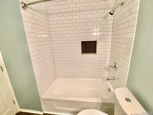 a bathroom with a bathtub and a shower