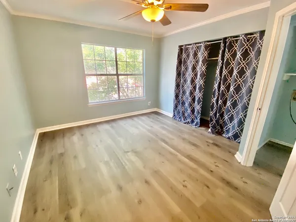 a view of an empty room with cabinet and a window