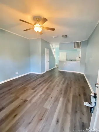 a view of a big room with wooden floor and staircase