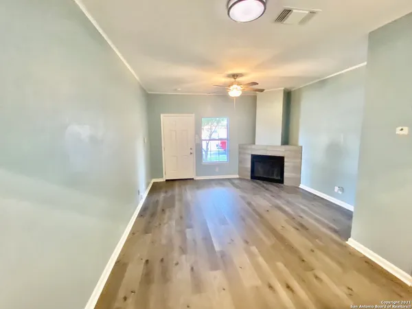 wooden floor in an empty room with a window