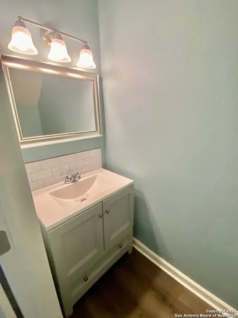 a bathroom with a sink and vanity