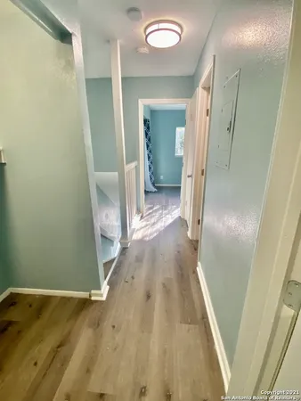 a view of hallway with wooden floor