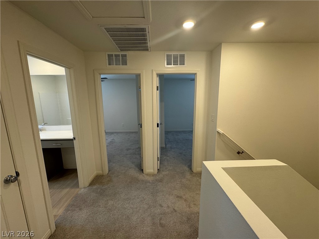 2821 Alcobaca Street Henderson, NV 89044 - Photo 12 of 24 A centrally located hallway connects a modern bathroom and two additional rooms.