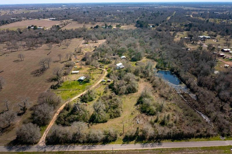 38241 Wiggins Road Hempstead, TX 77445 - Photo 15 of 48 an aerial view of house with yard and mountain in back