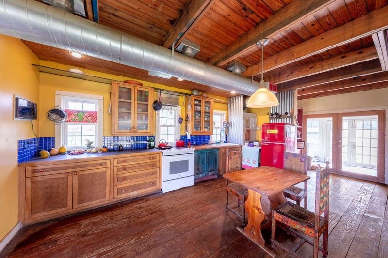 38241 Wiggins Road Hempstead, TX 77445 - Photo 23 of 48 a kitchen with a wooden table and chairs