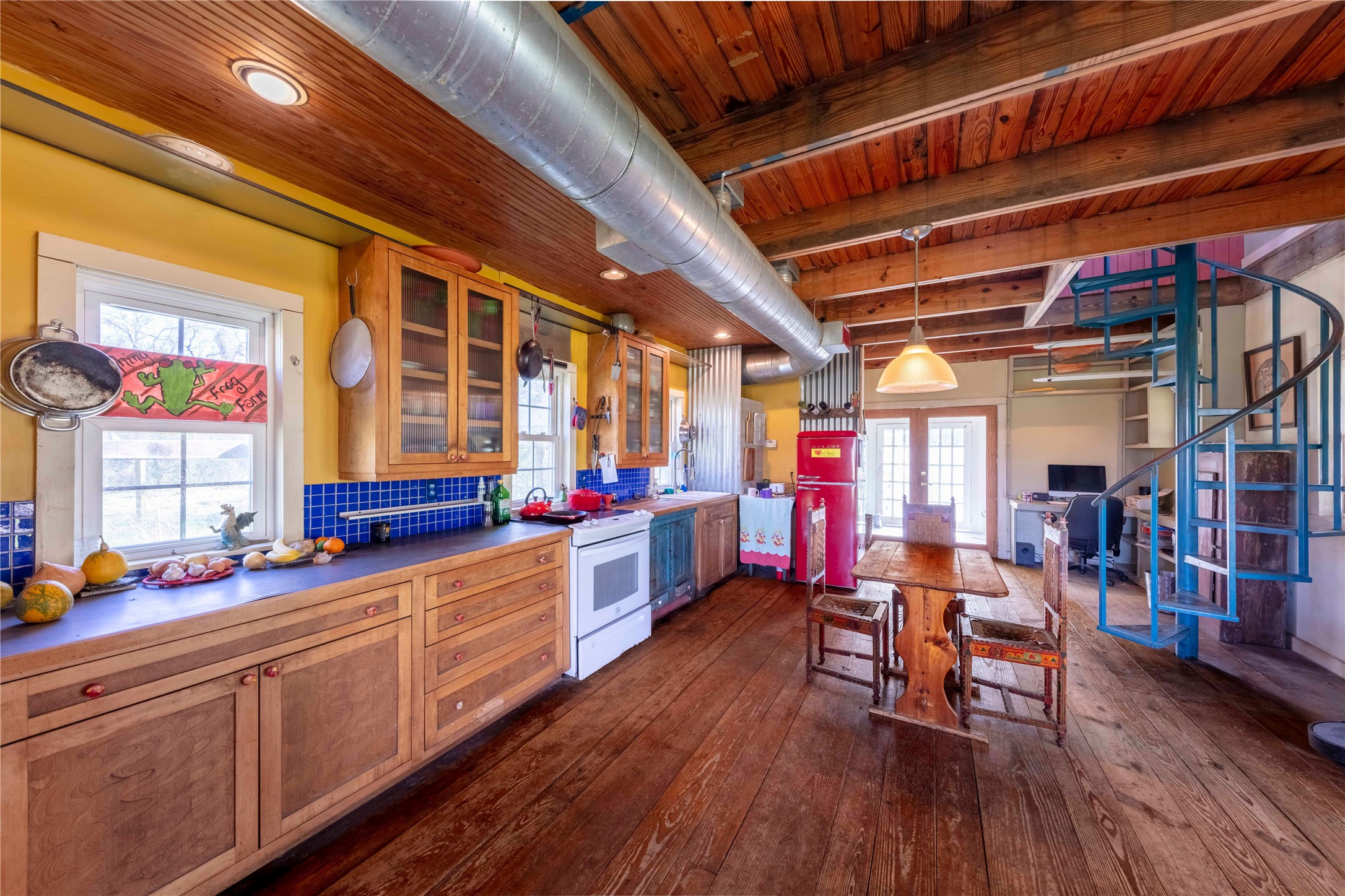 38241 Wiggins Road Hempstead, TX 77445 - Photo 25 of 48 a view of a kitchen with dining room and wooden floors