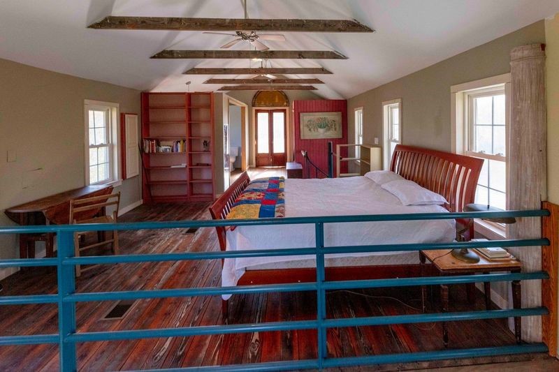 38241 Wiggins Road Hempstead, TX 77445 - Photo 30 of 48 a bedroom with a bed a rug and book shelf