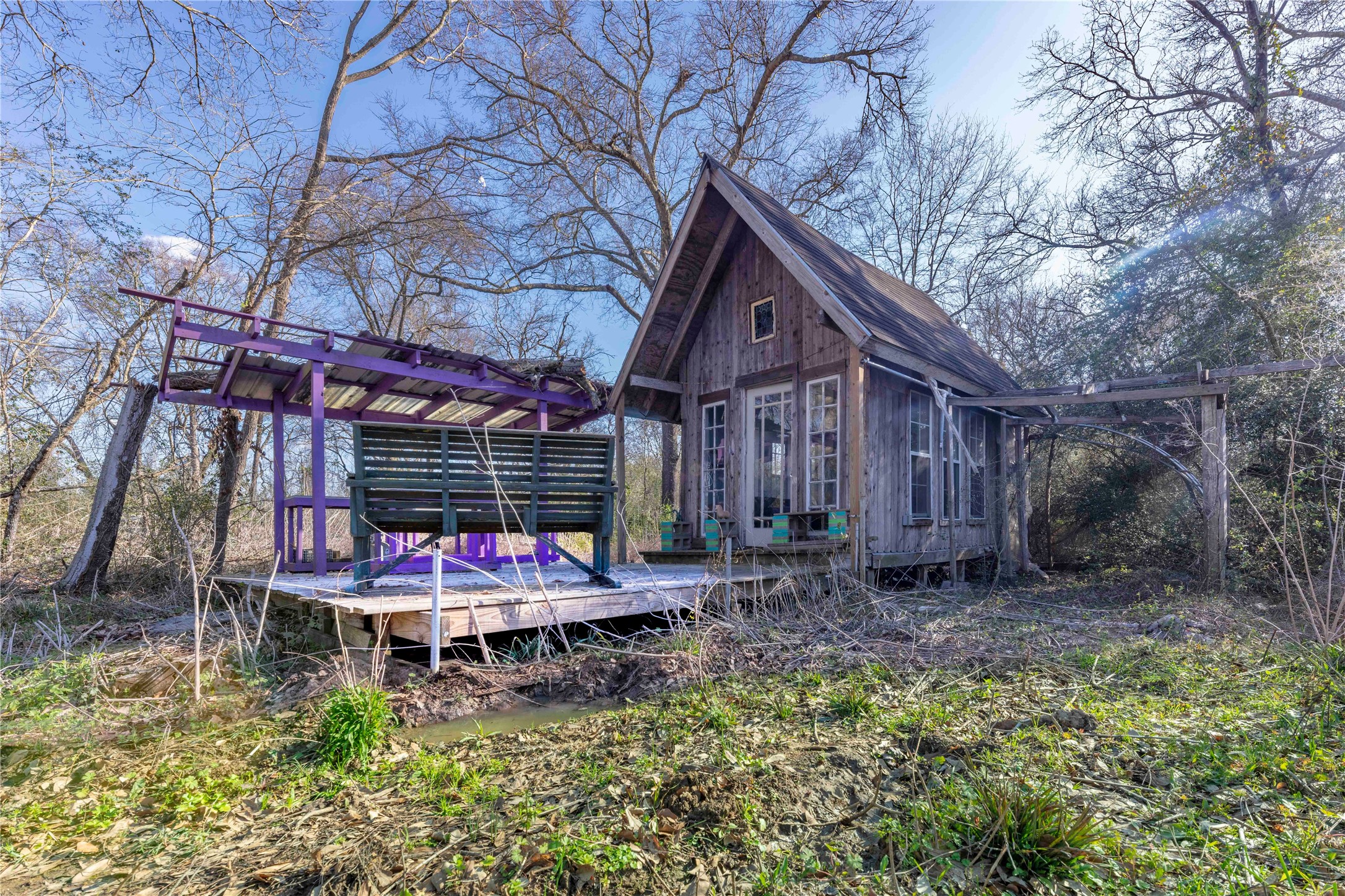38241 Wiggins Road Hempstead, TX 77445 - Photo 36 of 48 a wooden bench sitting in front of a house