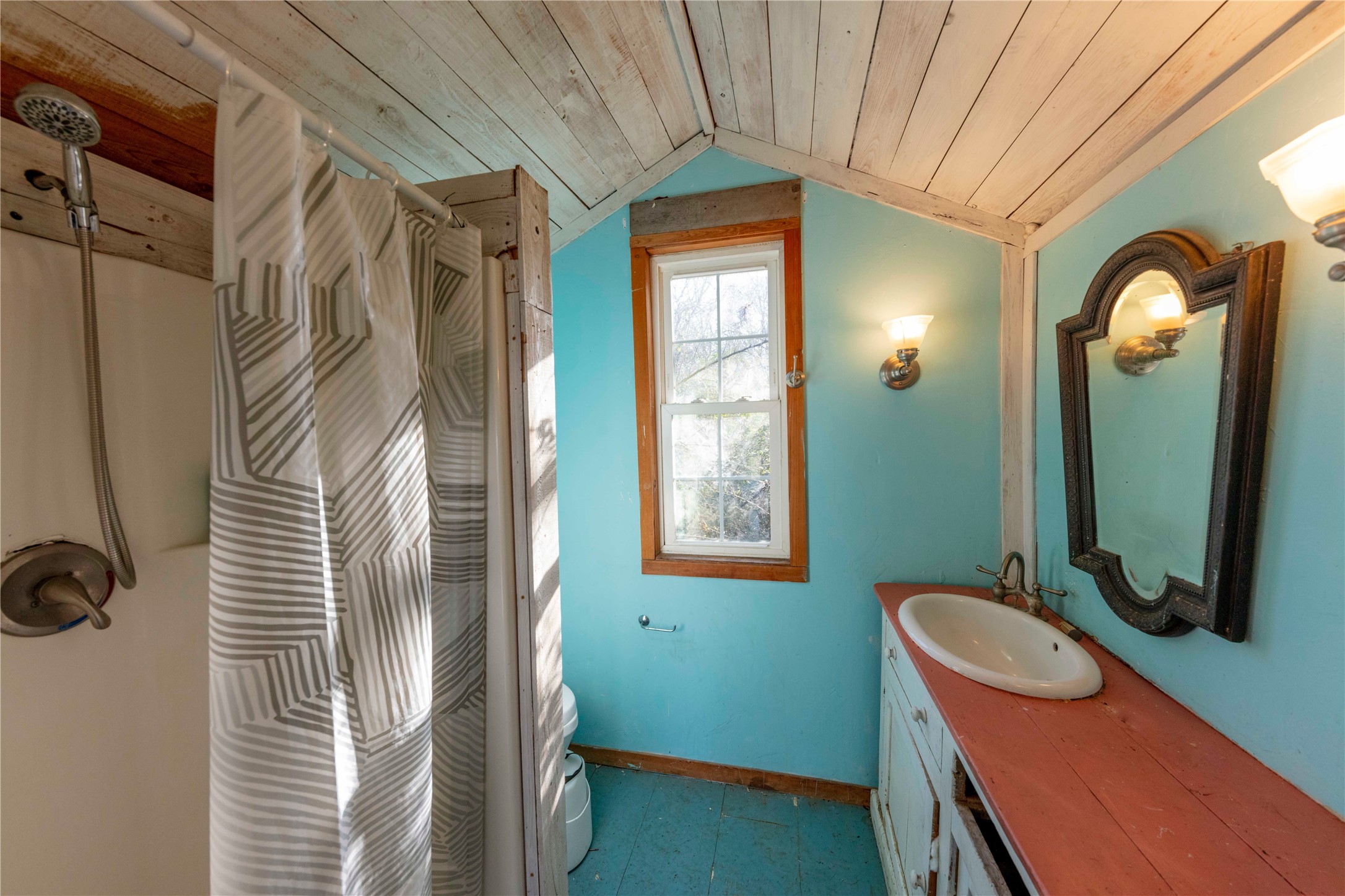 38241 Wiggins Road Hempstead, TX 77445 - Photo 40 of 48 a bathroom with a mirror a sink and a shower