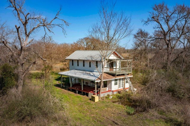 38241 Wiggins Road Hempstead, TX 77445 - Photo 9 of 48 a house with trees in front of it