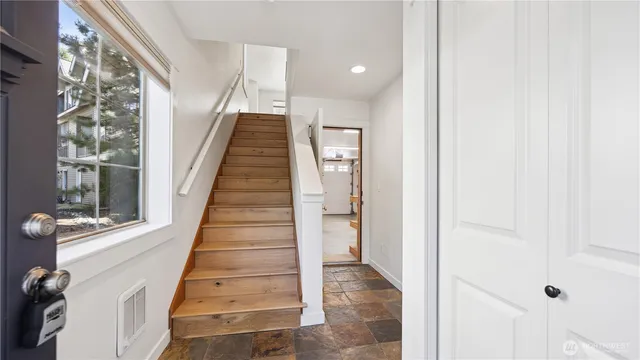 a view of entryway and hall with wooden floor