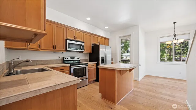 a kitchen with a sink stove and microwave