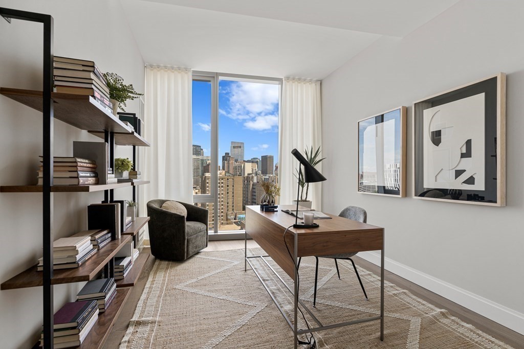 100 Shawmut Avenue, Unit PH A Boston, MA 02118 - Photo 15 of 39 a living room with furniture a rug and a large window