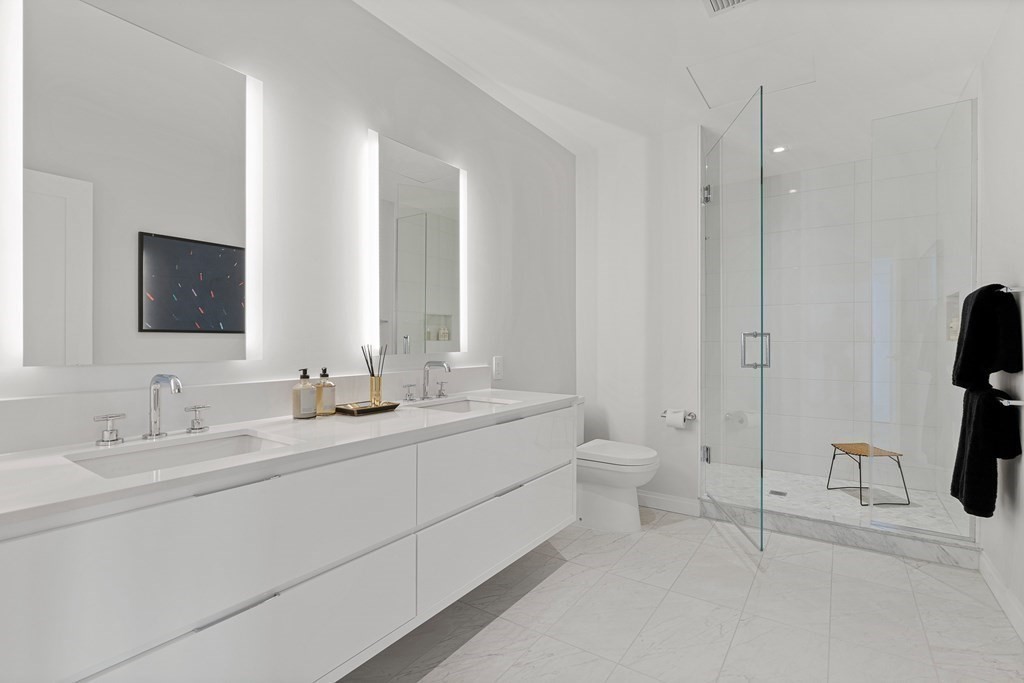 100 Shawmut Avenue, Unit PH A Boston, MA 02118 - Photo 16 of 39 a bathroom with a double vanity sink toilet mirror and bathtub