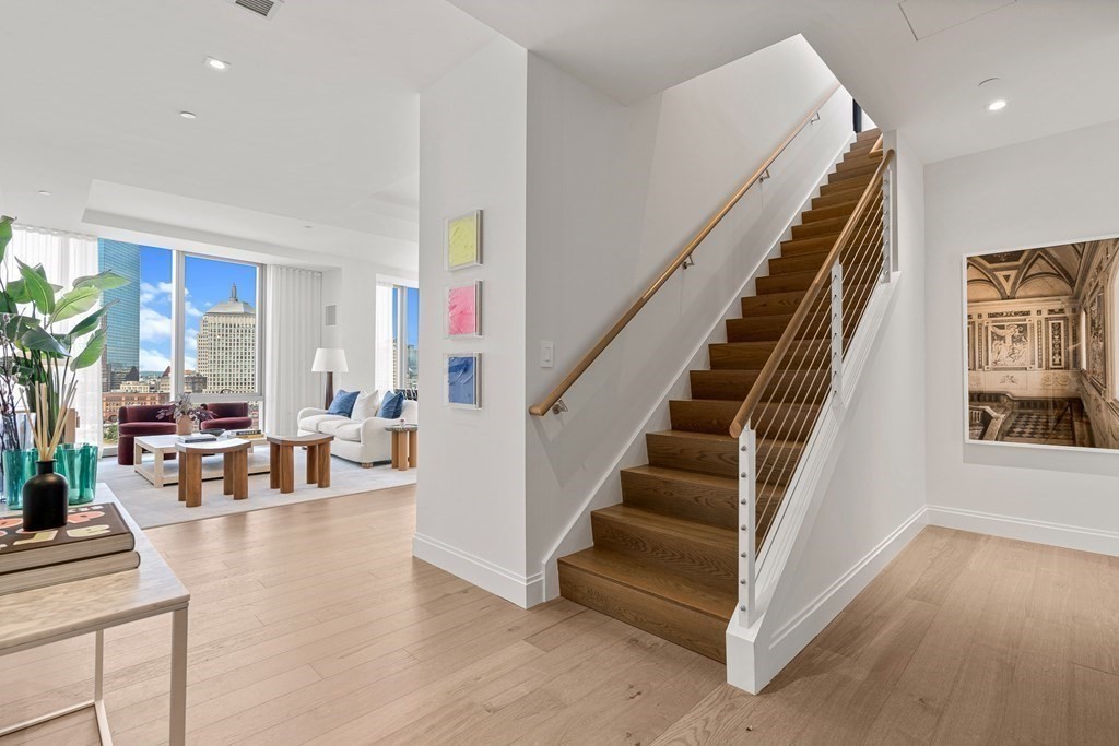 100 Shawmut Avenue, Unit PH A Boston, MA 02118 - Photo 18 of 39 a living room with furniture and a dining table with wooden floor