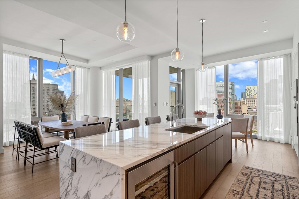 100 Shawmut Avenue, Unit PH A Boston, MA 02118 - Photo 2 of 39 a kitchen with sink refrigerator and large windows