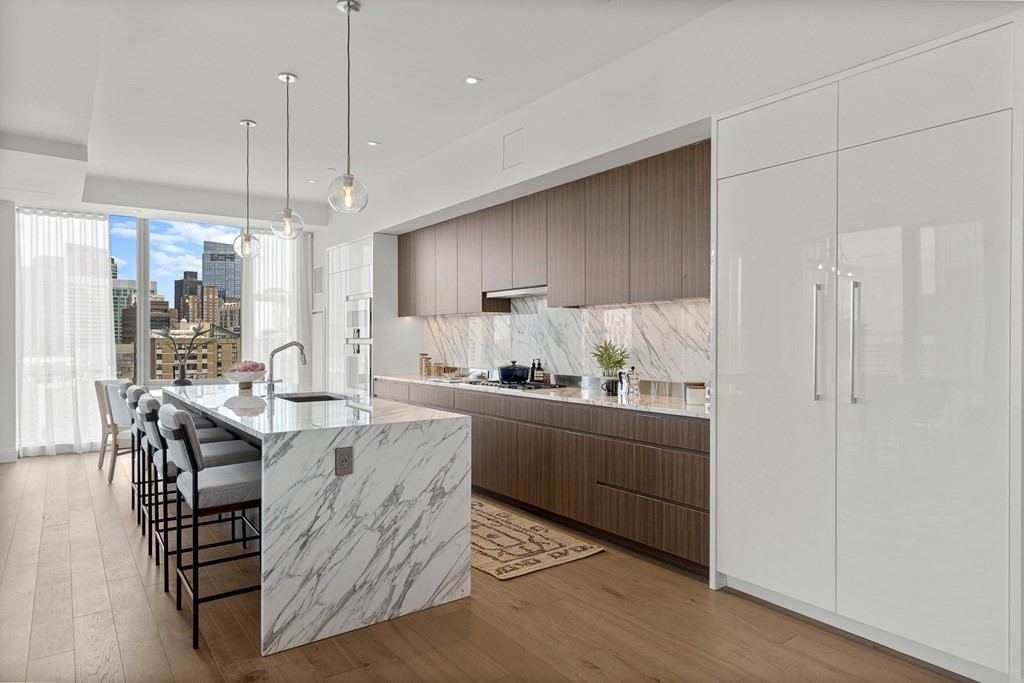 100 Shawmut Avenue, Unit PH A Boston, MA 02118 - Photo 3 of 39 a kitchen with granite countertop a table chairs refrigerator and microwave