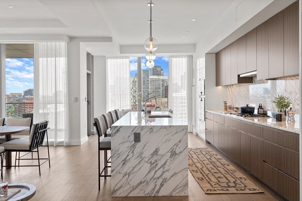 100 Shawmut Avenue, Unit PH A Boston, MA 02118 - Photo 4 of 39 a large kitchen with a large window and stainless steel appliances