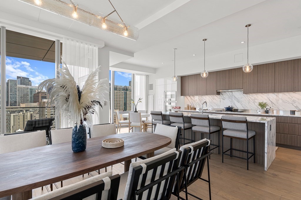 100 Shawmut Avenue, Unit PH A Boston, MA 02118 - Photo 5 of 39 a kitchen with a table chairs stove and cabinets