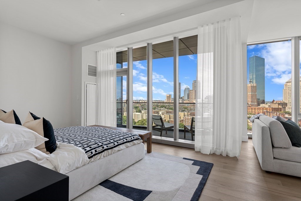 100 Shawmut Avenue, Unit PH A Boston, MA 02118 - Photo 7 of 39 a large bedroom with a bed and glass window