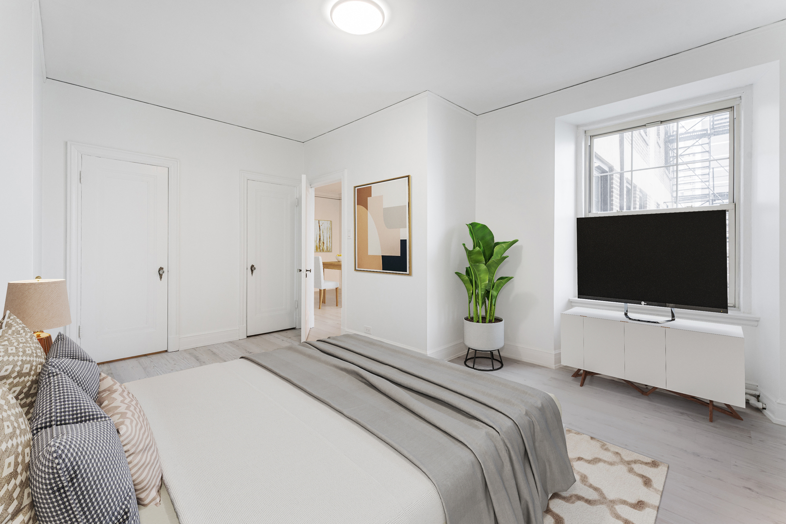 6101 North Sheridan Road, Unit 8G Chicago, IL 60660 - Photo 8 of 15 a bedroom that has a bed a television and a window