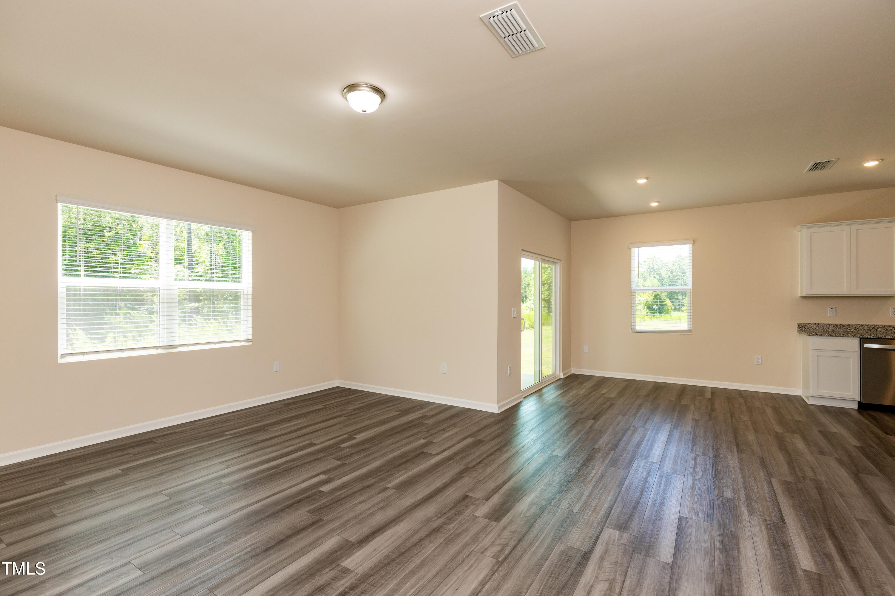 1444 Heron Pond Street Raleigh, NC 27604 - Photo 11 of 37 an empty room with wooden floor and windows