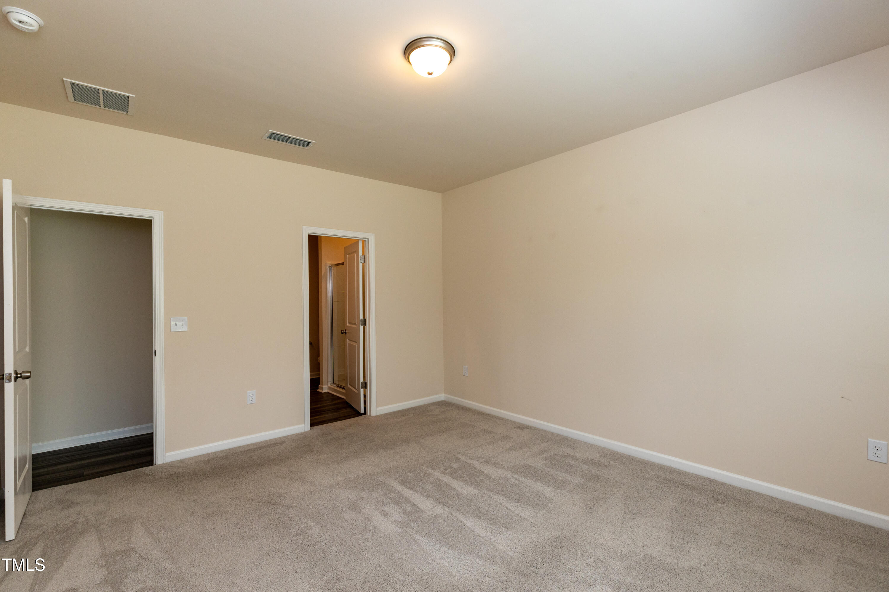1444 Heron Pond Street Raleigh, NC 27604 - Photo 22 of 37 an empty room with closet and mirror