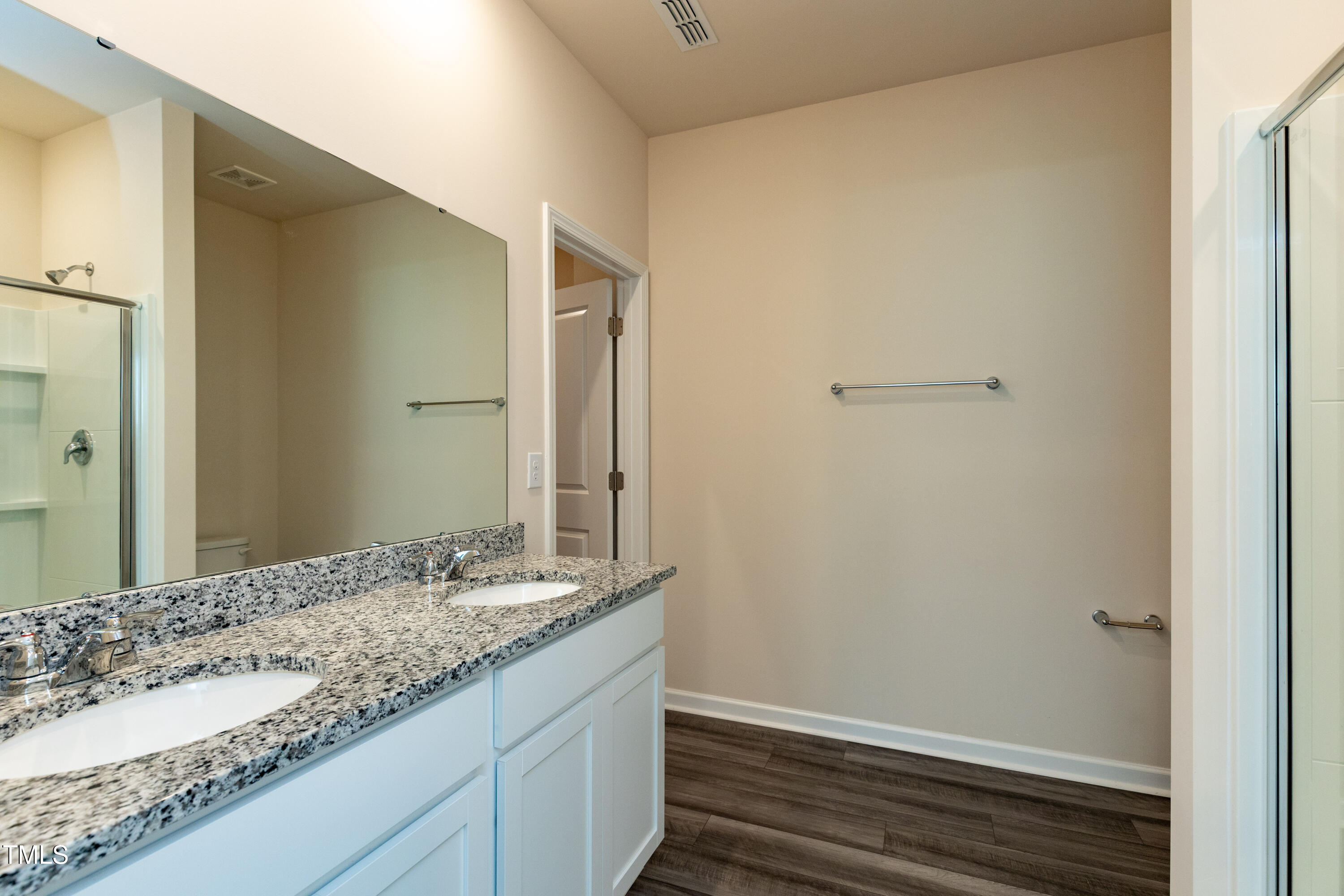 1444 Heron Pond Street Raleigh, NC 27604 - Photo 25 of 37 a bathroom with a granite countertop sink and a mirror