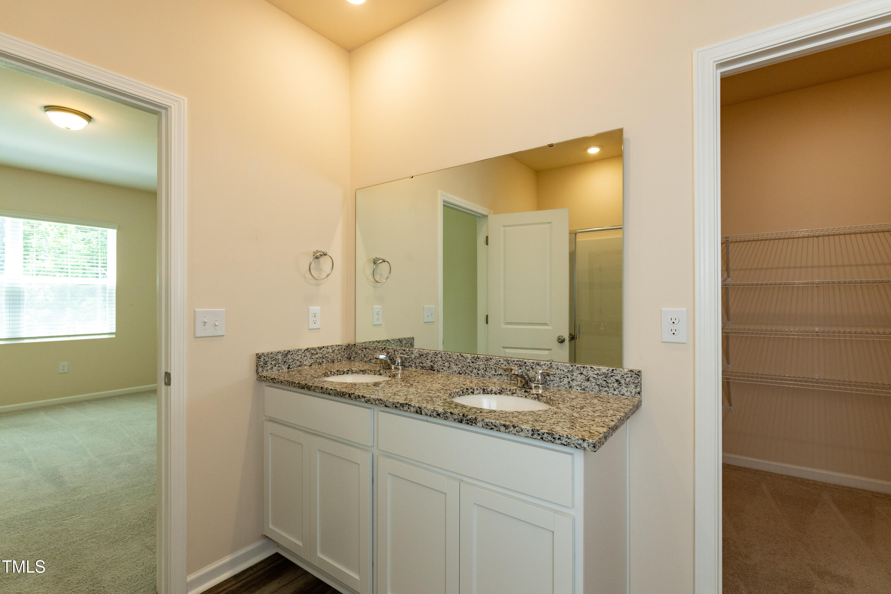 1444 Heron Pond Street Raleigh, NC 27604 - Photo 26 of 37 a bathroom with a granite countertop sink and a mirror