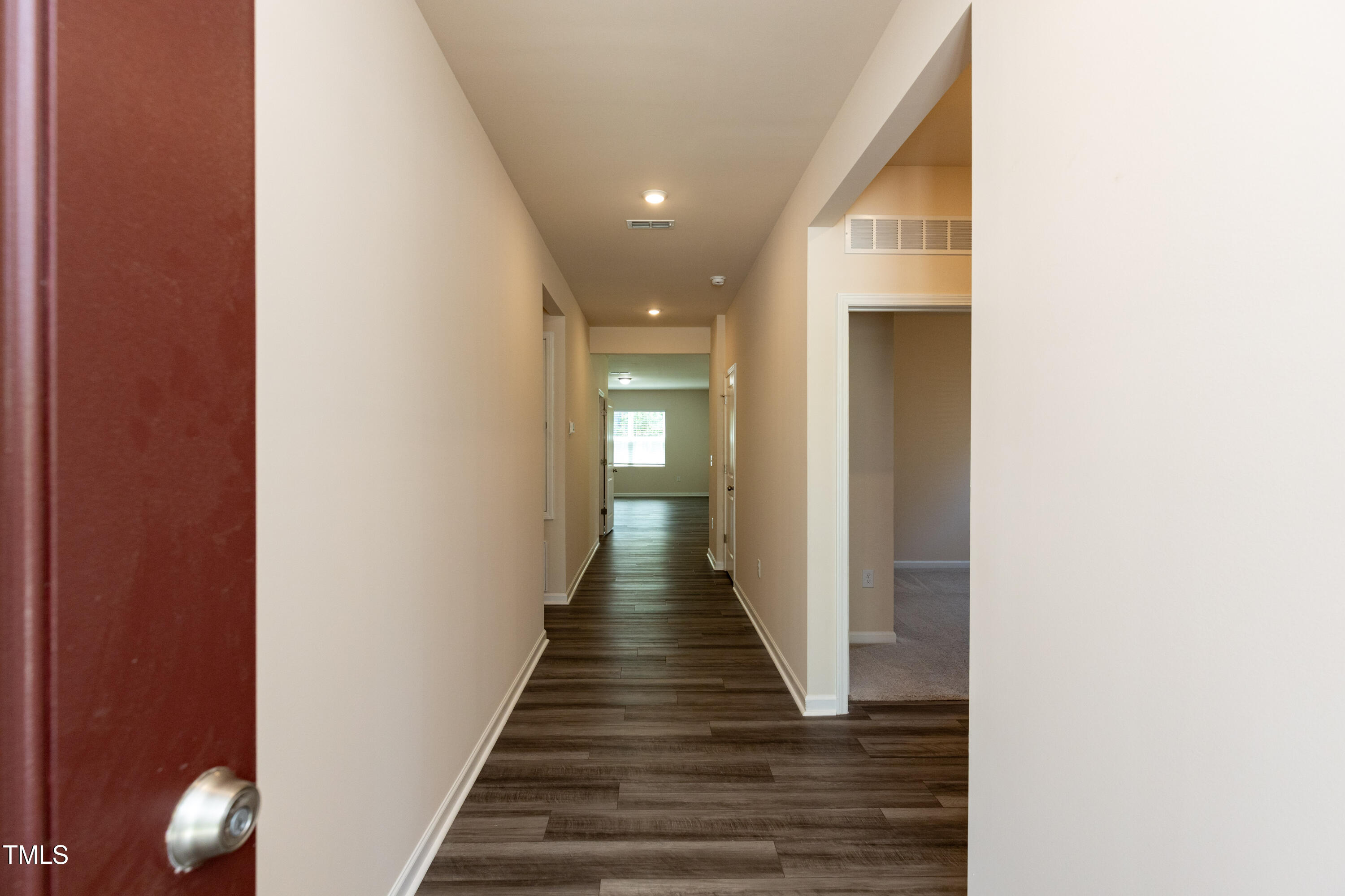 1444 Heron Pond Street Raleigh, NC 27604 - Photo 3 of 37 a view of a hallway with wooden floor