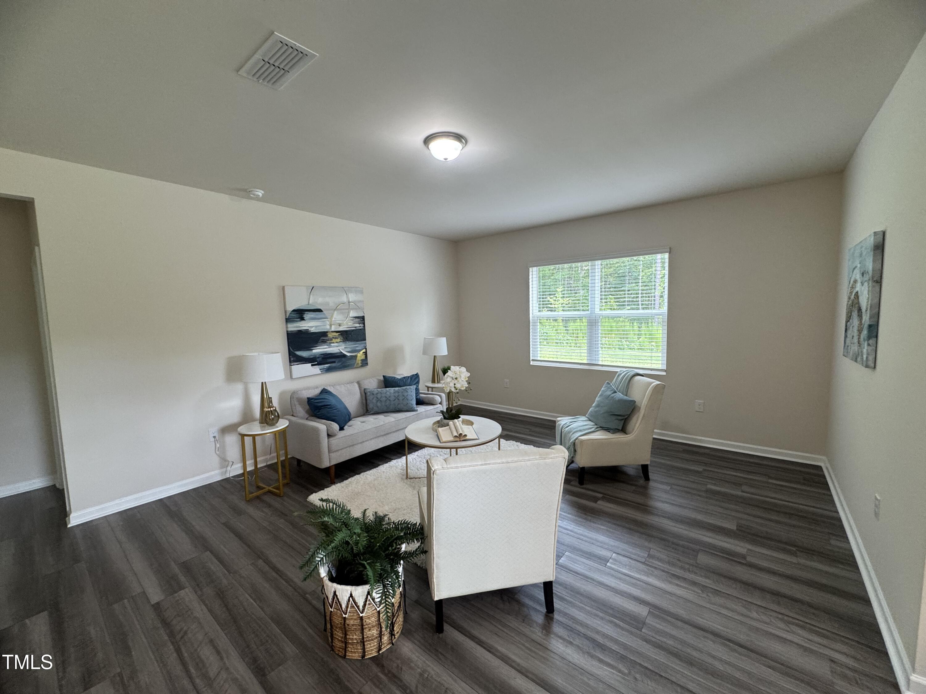 1444 Heron Pond Street Raleigh, NC 27604 - Photo 35 of 37 a living room with furniture and a wooden floor