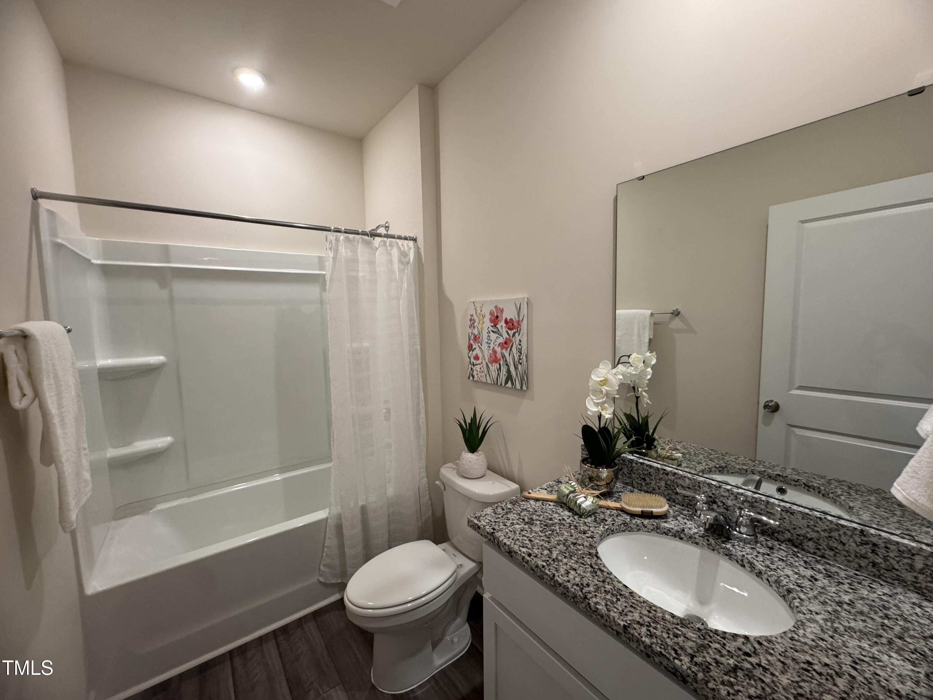 1444 Heron Pond Street Raleigh, NC 27604 - Photo 36 of 37 a bathroom with a granite countertop sink toilet and shower