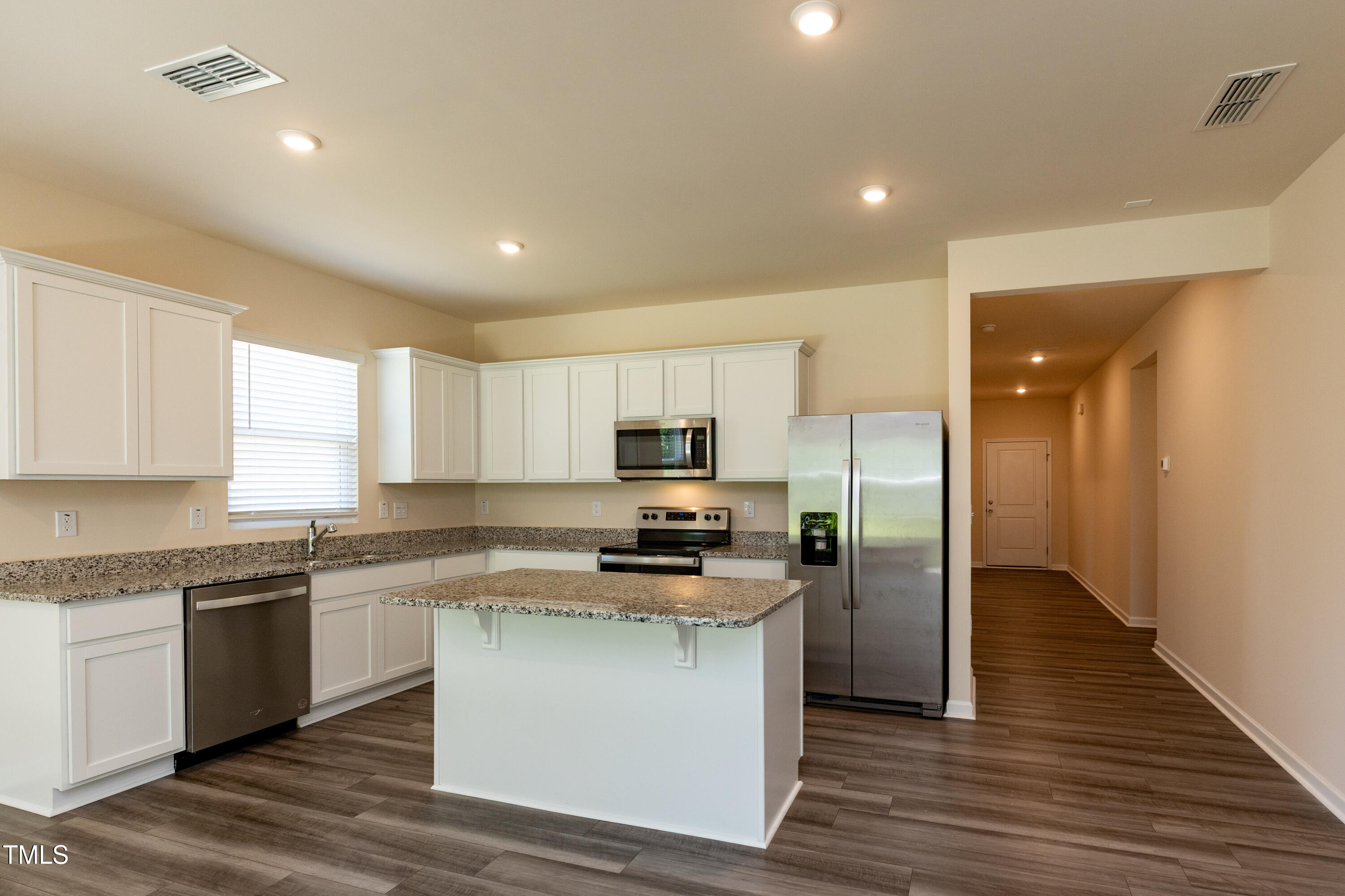 1444 Heron Pond Street Raleigh, NC 27604 - Photo 5 of 37 a kitchen with a refrigerator and a stove top oven