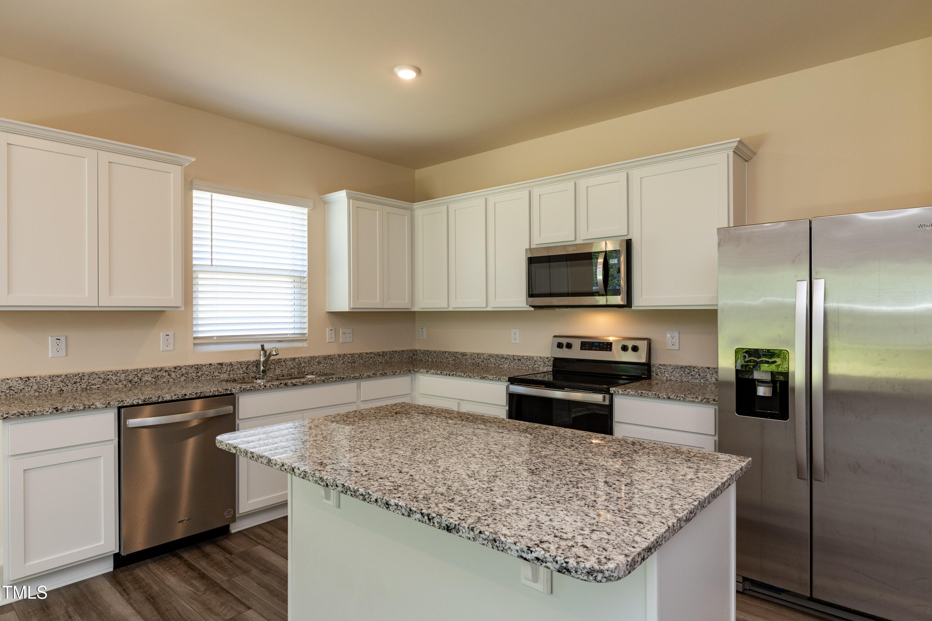 1444 Heron Pond Street Raleigh, NC 27604 - Photo 6 of 37 a kitchen with stainless steel appliances granite countertop a sink stove microwave and refrigerator