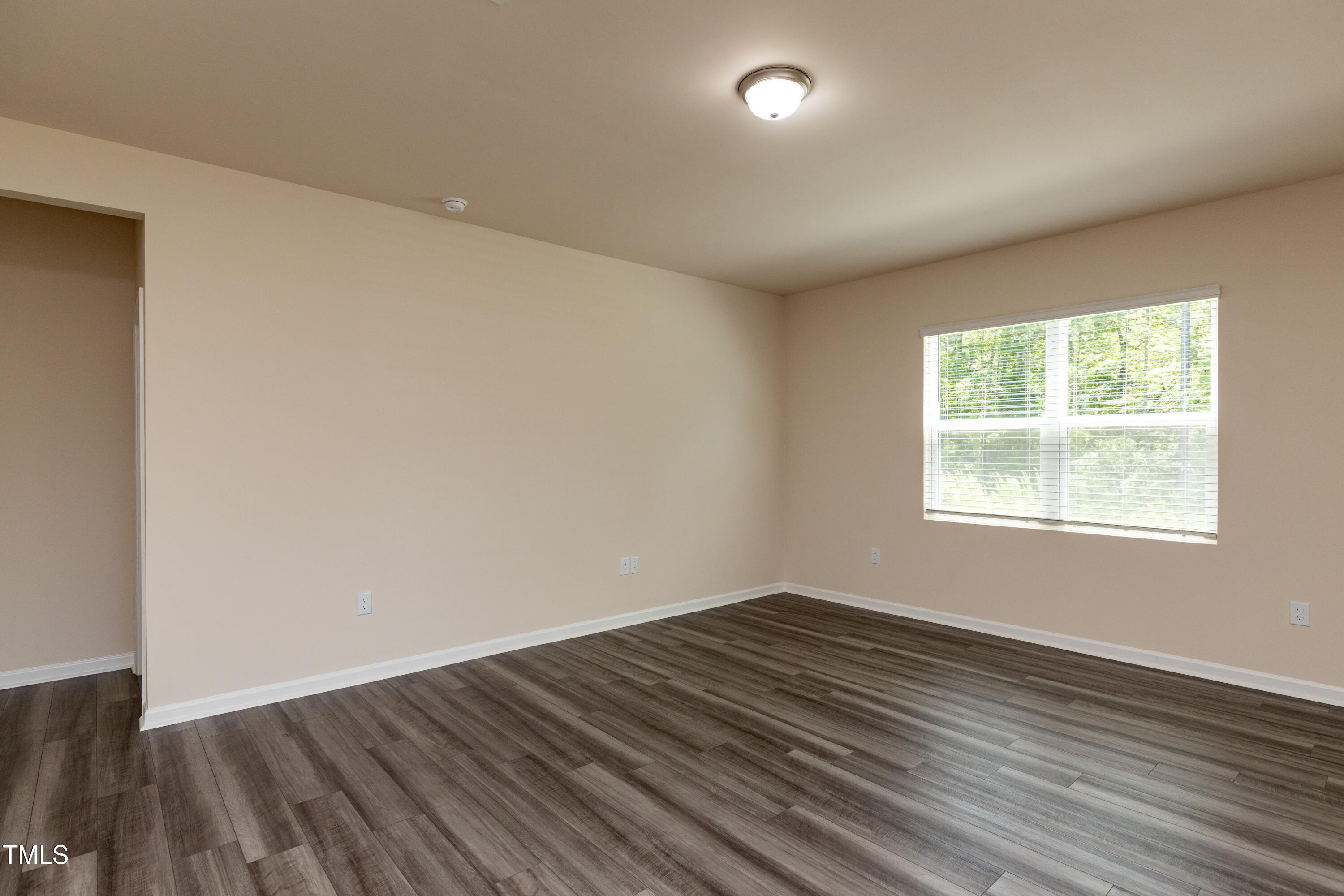 1444 Heron Pond Street Raleigh, NC 27604 - Photo 10 of 37 an empty room with wooden floor and windows