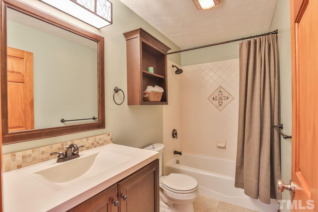 508 Ridge View Pittsboro, NC 27312 - Photo 13 of 30 Hall bath with new cabinet, counter light, etc. Tile surround at tub