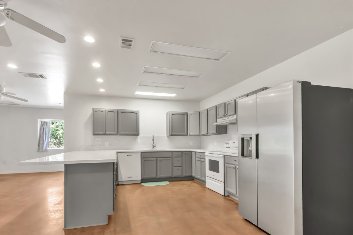 1004 22 Hills Road Gause, TX 77857 - Photo 14 of 40 a large white kitchen with cabinets a sink and stainless steel appliances