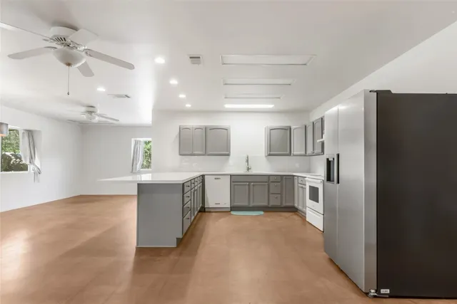 a view of kitchen with sink and microwave