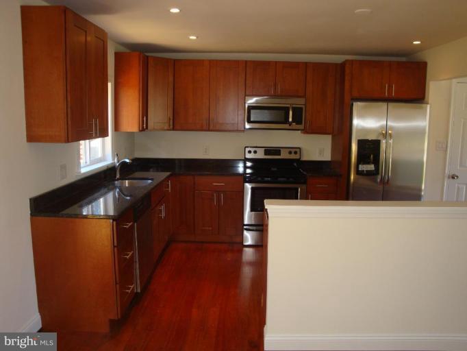 3702 Stonesboro Road Fort Washington, MD 20744 - Photo 4 of 8 a kitchen with stainless steel appliances granite countertop a stove a sink and a refrigerator