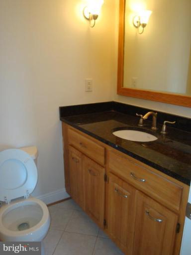 3702 Stonesboro Road Fort Washington, MD 20744 - Photo 6 of 8 a bathroom with a granite countertop sink and a mirror