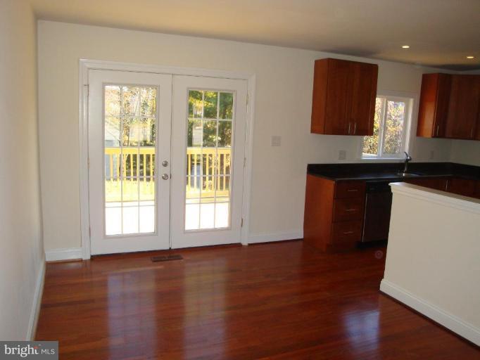 3702 Stonesboro Road Fort Washington, MD 20744 - Photo 8 of 8 a kitchen with granite countertop wooden floors and wide window