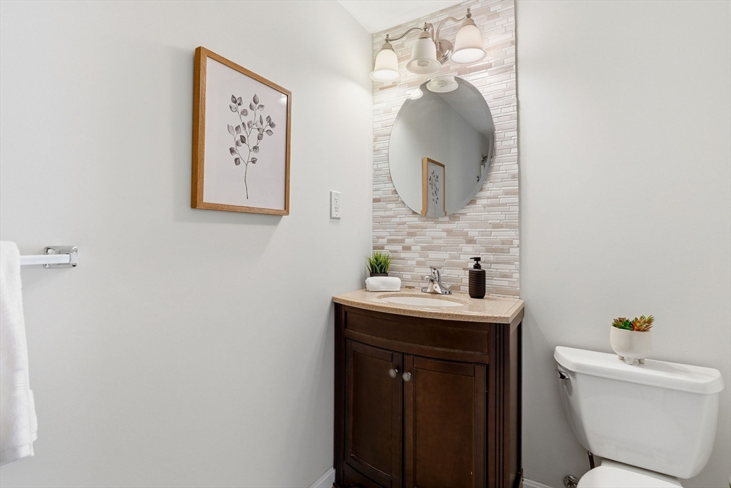 80 Swan Street, Unit 223 Lowell, MA 01852 - Photo 13 of 20 a bathroom with a toilet sink and mirror
