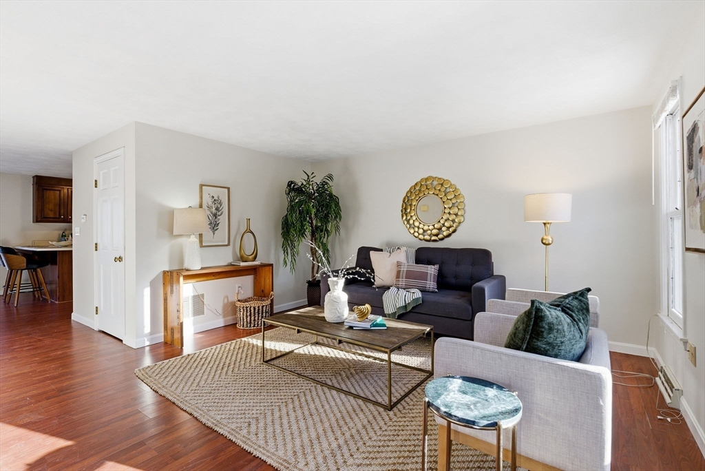 80 Swan Street, Unit 223 Lowell, MA 01852 - Photo 2 of 20 a living room with furniture a rug and a table