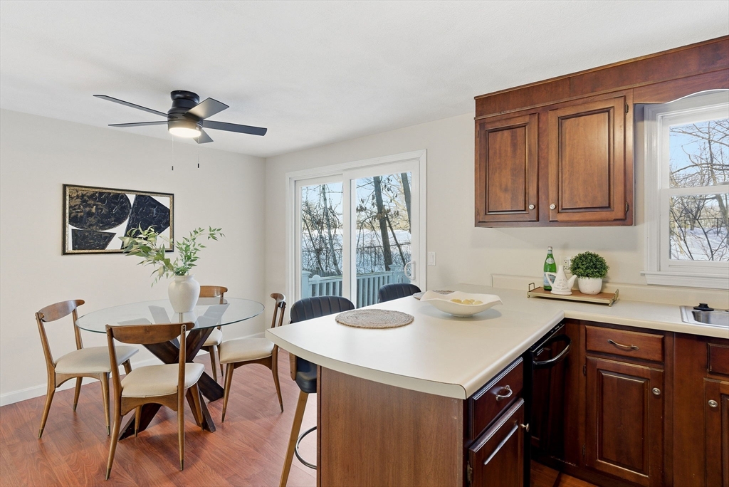 80 Swan Street, Unit 223 Lowell, MA 01852 - Photo 4 of 20 a kitchen with a table chairs cabinets and appliances