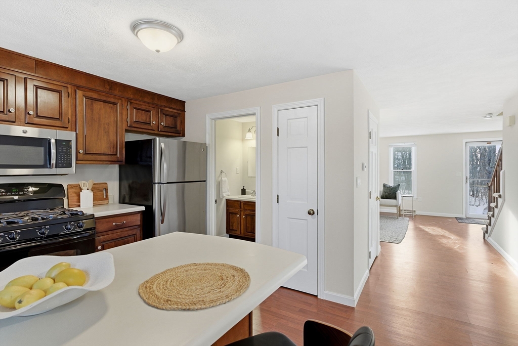 80 Swan Street, Unit 223 Lowell, MA 01852 - Photo 9 of 20 a kitchen with stainless steel appliances a refrigerator and a stove top oven