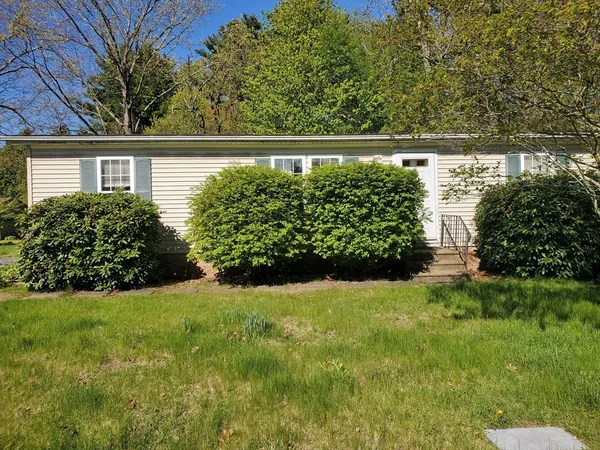 a view of house with yard